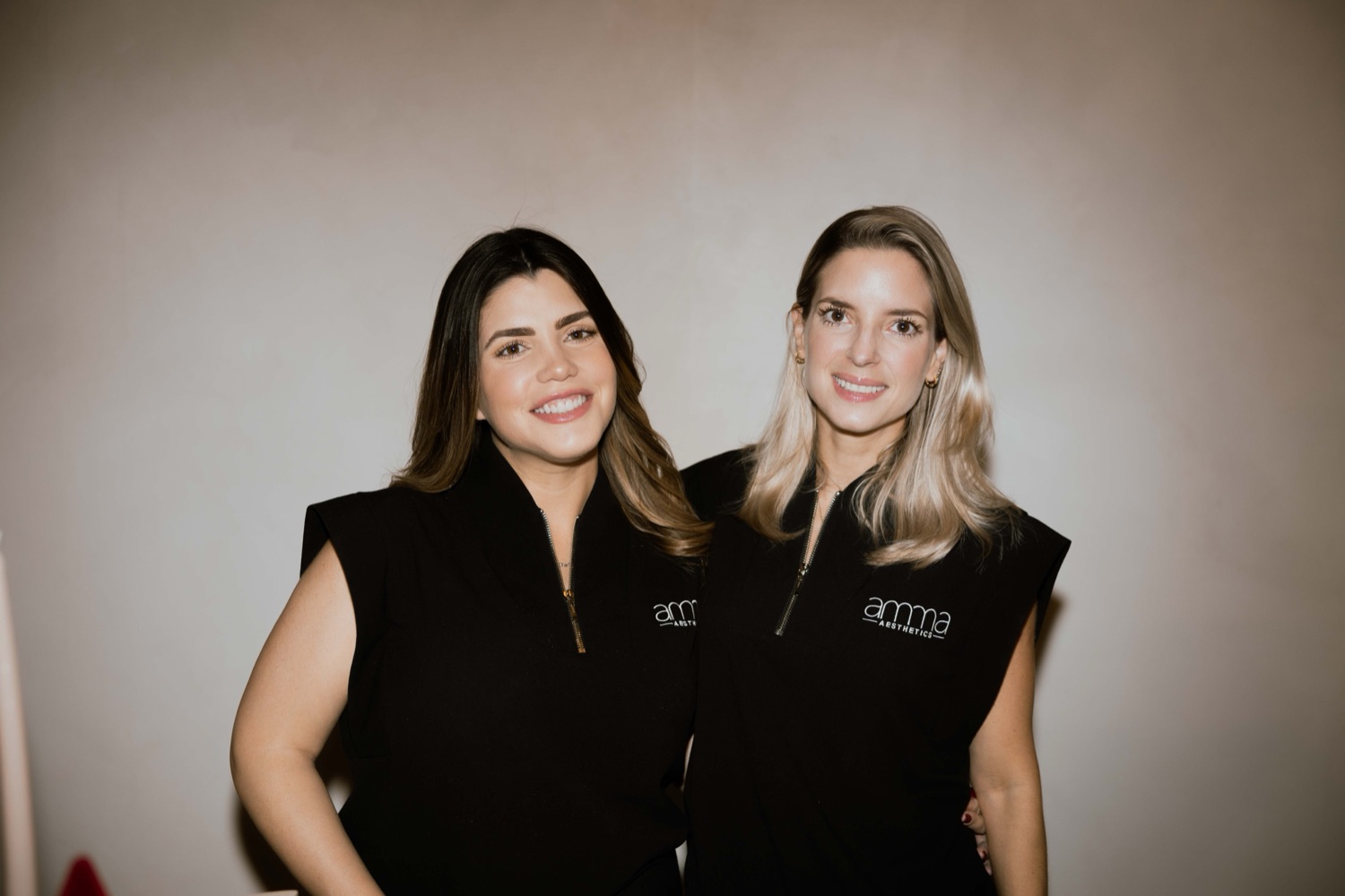 The founders of AMMA Aesthetics South Miami welcoming a member for a treatment