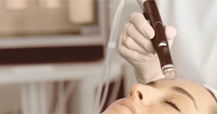 Relaxed client receiving a HydraFacial treatment at AMMA Aesthetics South Miami